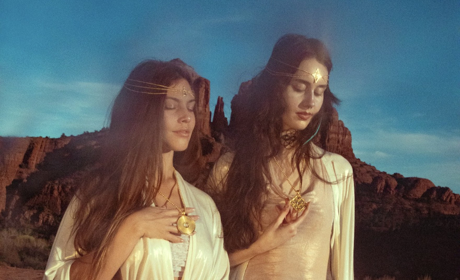 Two women in Sedona holding Dolphin Technology pendants